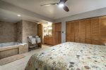 master bedroom suite, king size bed, closet, jacuzzi hot tub, towel rack, ceiling fan